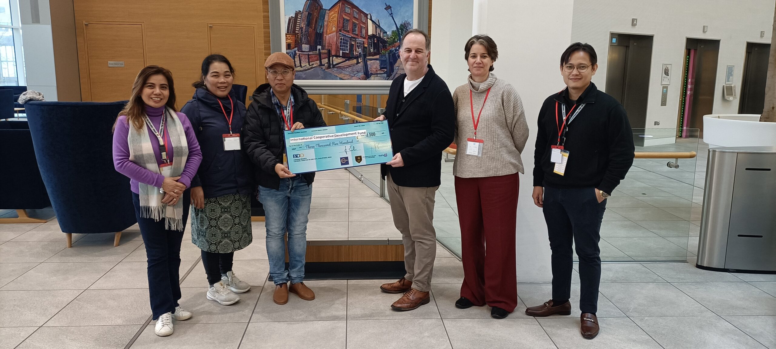A group fo people accepting a large cheque